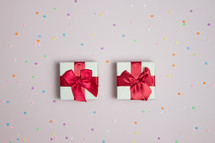 Two small presents on confetti background