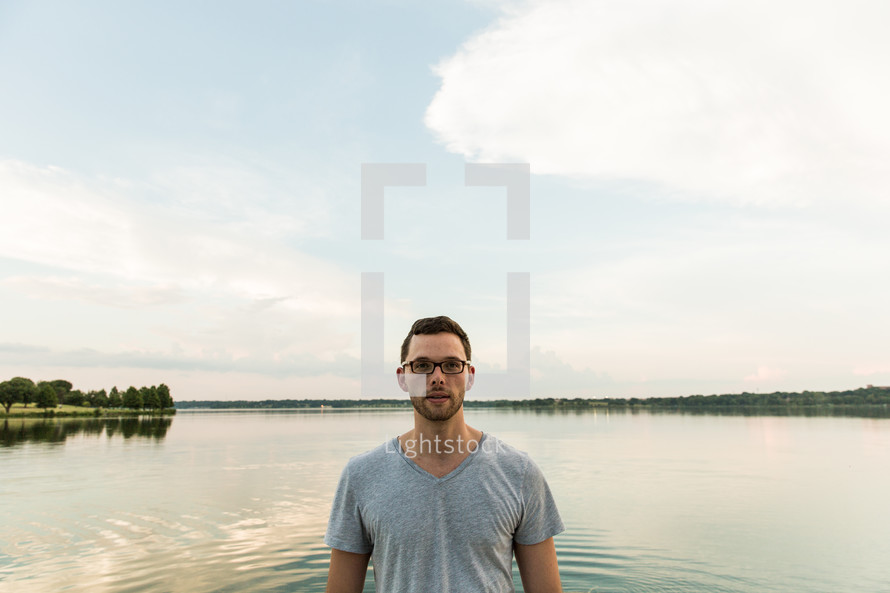 man standing in front of a lake 