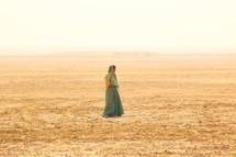 woman standing in a desert 