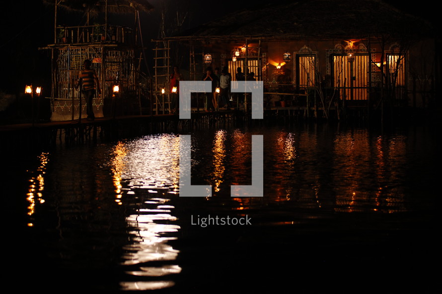 lights from a village by water at night