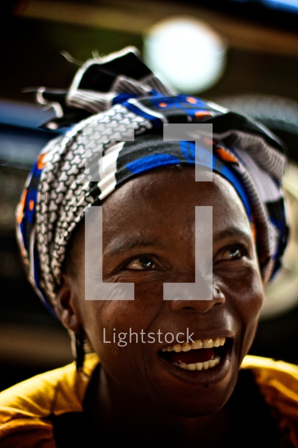 woman with a scarf on her head in Africa 