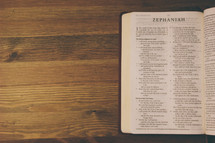 Open Bible on a wooden table.