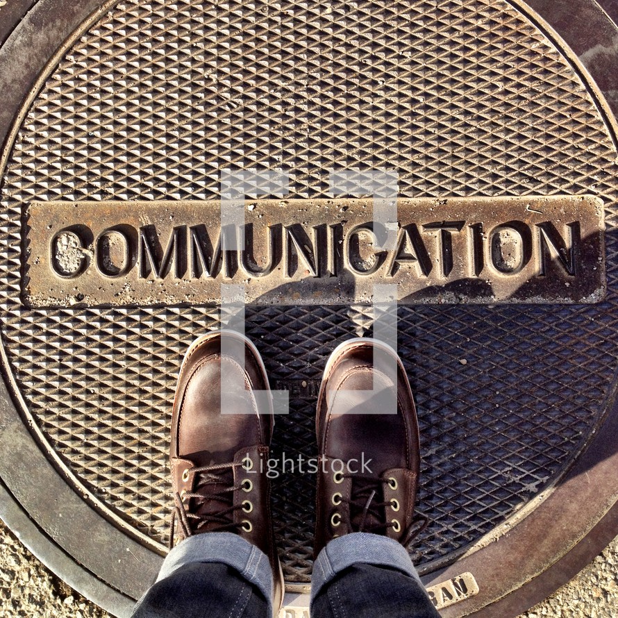 word communication on a manhole cover