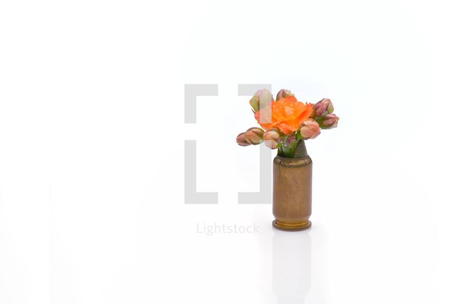 Orange watercolor flower into a riffle bullet symbolizing flower power against isolated on white