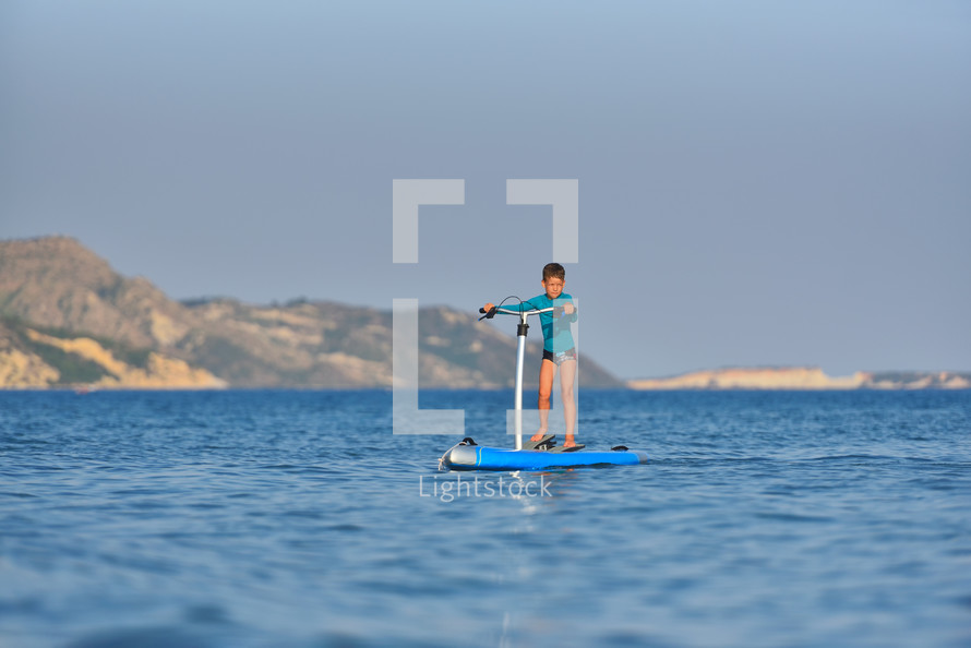active kid on a Hobie Stand Up Paddle board