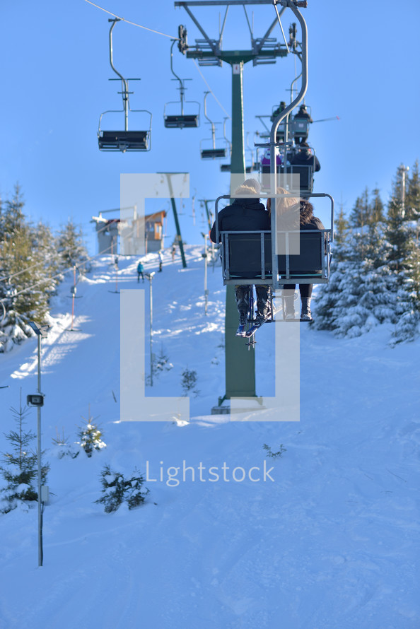 People on holiday coming to ski, use the cable car to reach the summit