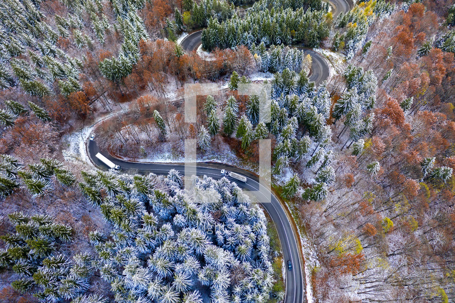 aerial view over a winding winter road 