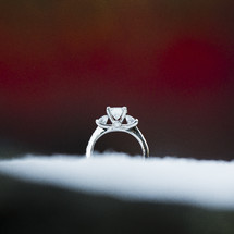 an engagement ring in the snow