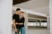 couple hugging in a parking garage 