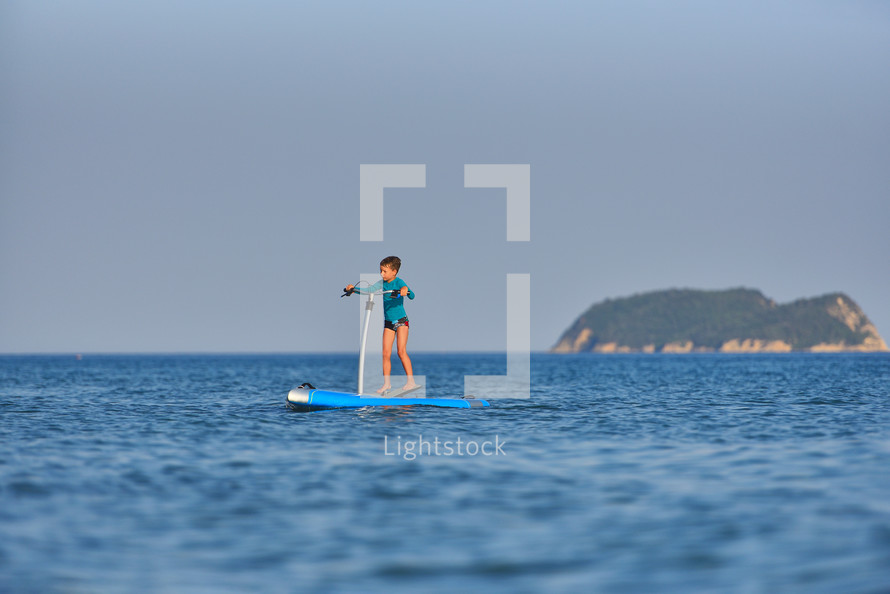 active kid on a Hobie Stand Up Paddle board