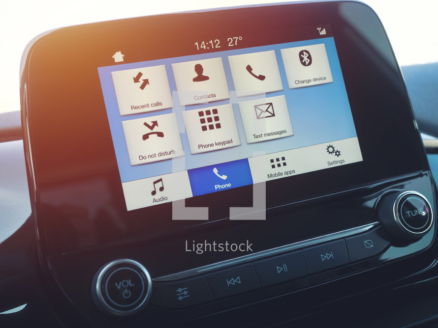 Smart multimedia in-car display with hands-free phone control. Modern navigation device on center of the car control panel.
