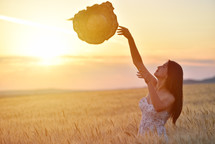 woman standing in golden wheat in a field 
