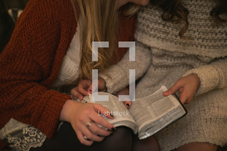 Two women studying the Bible together.