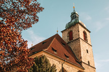 Church of St Henry and St Kunhuta in Prague. Autumn season, orange tree. Bohemia. High quality photo