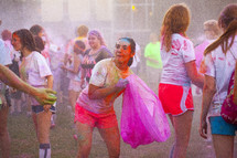 teens tossing color packets at a color run 