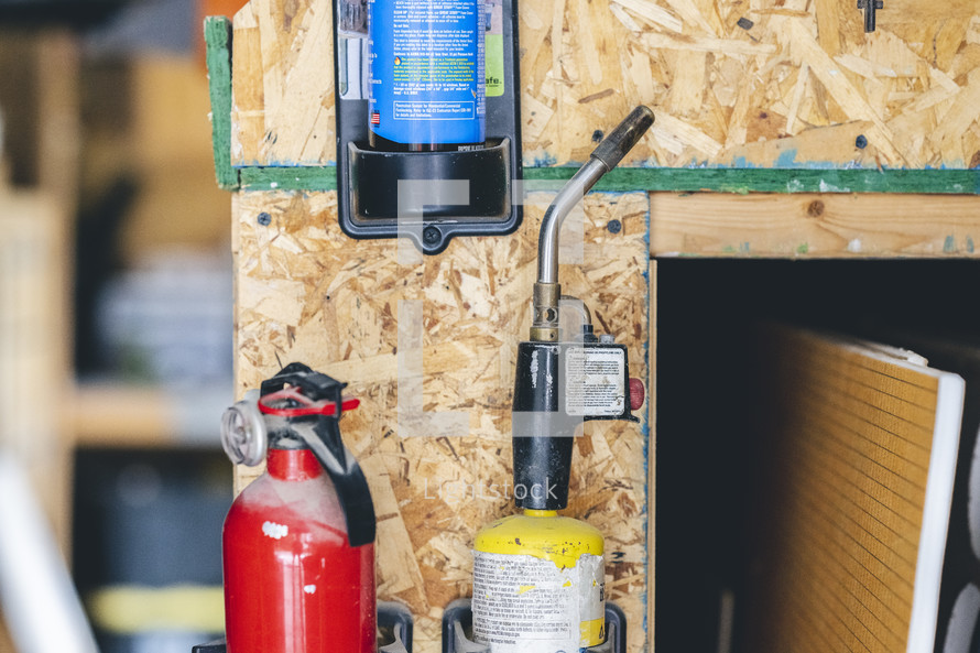 torch and fire extinguisher in a tool shed