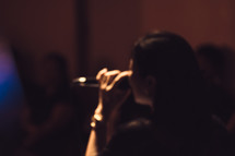 a woman singing into a microphone 