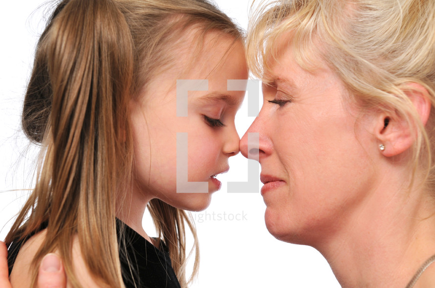 mother and daughter touching noses 