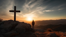 A man standing by a cross thinking at sunset. 