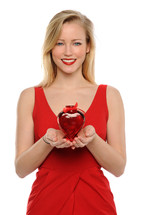 woman in a red dress holding a Valentine's gift 