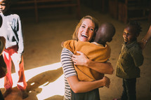 missionary woman hugging a child 
