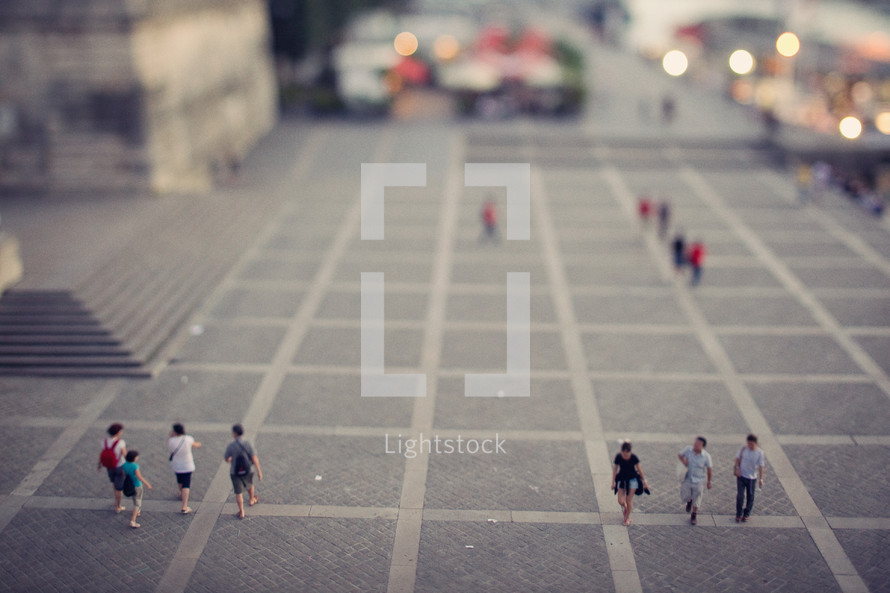 people walking on a city square