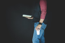 man holding a Bible and coffee cup 