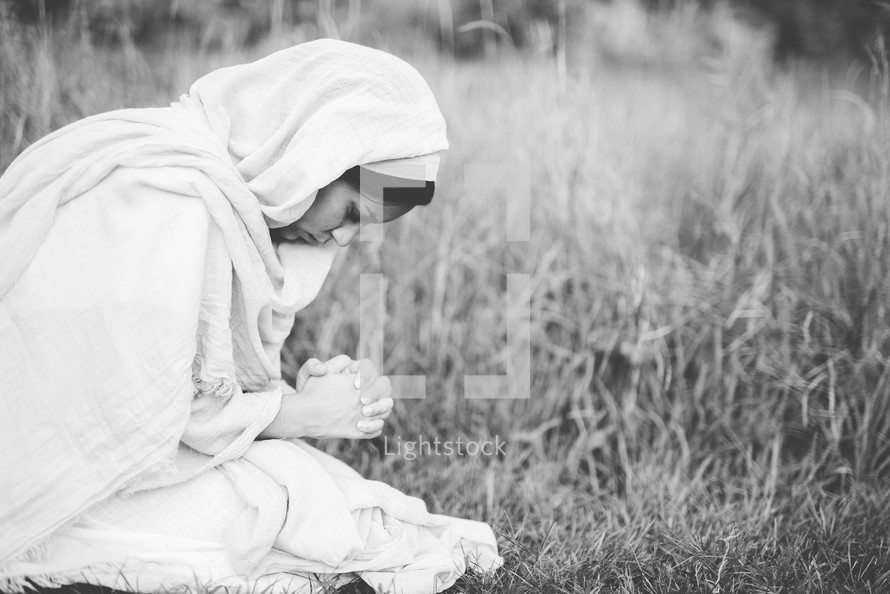 woman of biblical times kneeling in prayer 