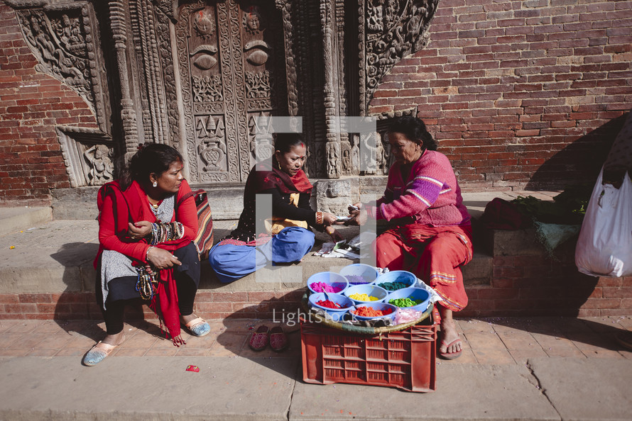 women painting on the streets of Tibet 