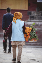 man with a banner of flowers in Nepal 