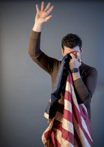 a man crying into an American flag 