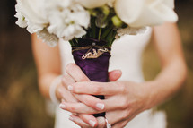 brides hands holding a bouquet