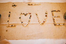 the word 'love' spelled out with rocks - Valentines Day