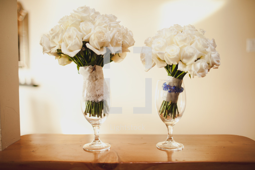 bridal bouquets in wine glasses