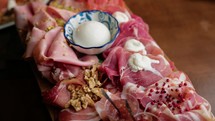 Typical Tuscan Appetizer With Salami On A Wooden Chopping Board