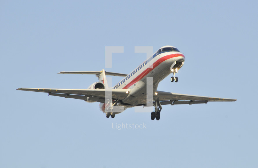 Commercial airplane with its landing gear down. Jet passenger aircraft. American Airlines.