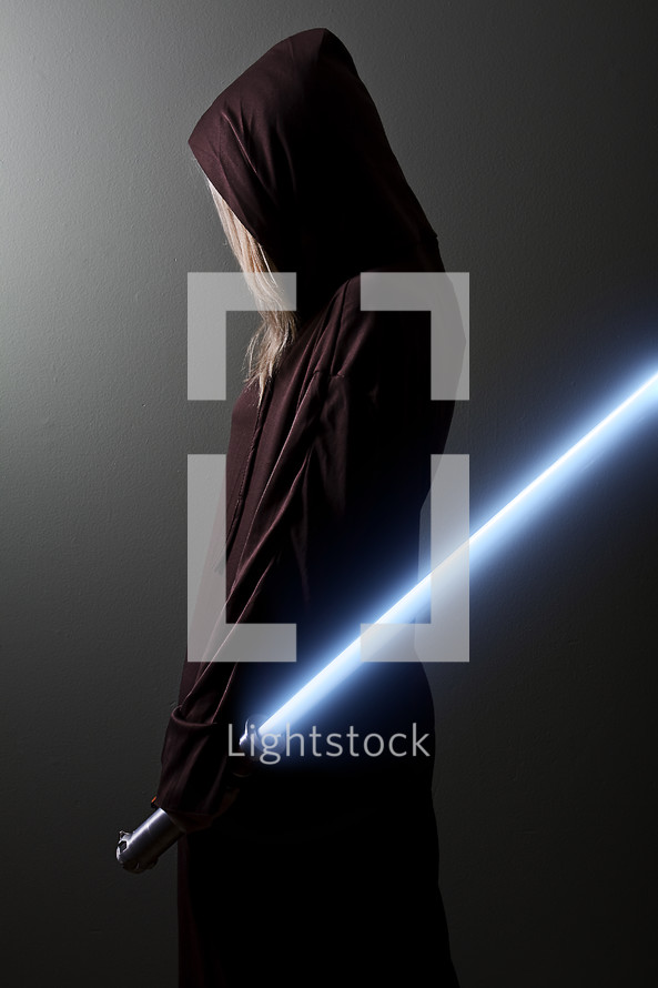 Jedi Guardian; woman in brown robe holding a blue lightsaber.