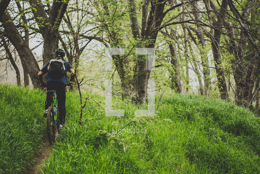 riding a bike through a forest