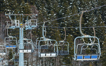 Chair lift on over the snowy forest at Abetone, Italy.