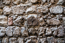 cross stamp on a stone wall 