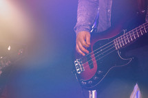A bass guitarist performs at a church concert