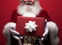 Santa holding a Christmas gift 
