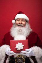Santa holding a Christmas gift 