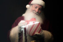 Santa opening a magical gift 