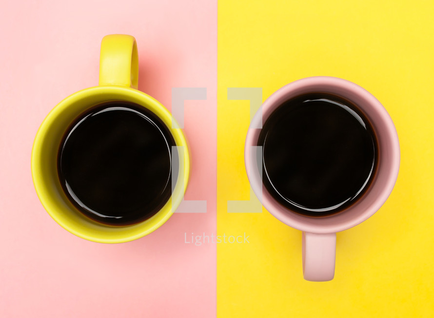 coffee mugs on pink and yellow paper 