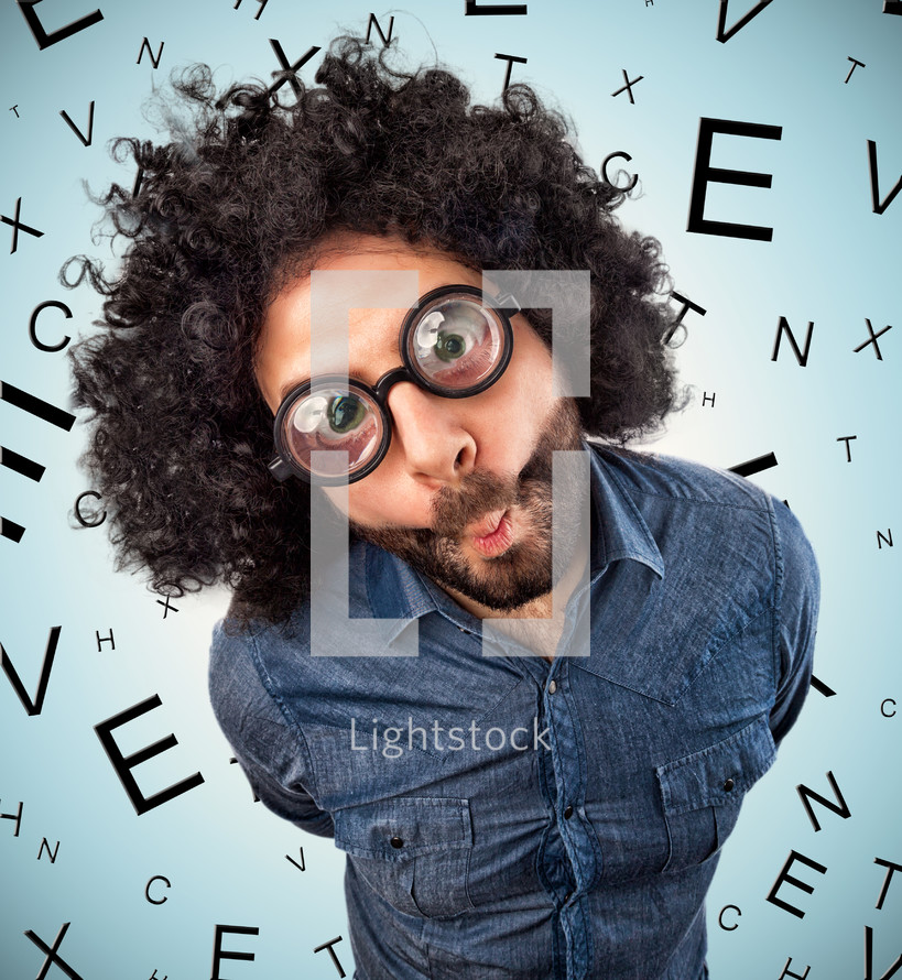 man with thick glasses on background with letters for checking eyesight