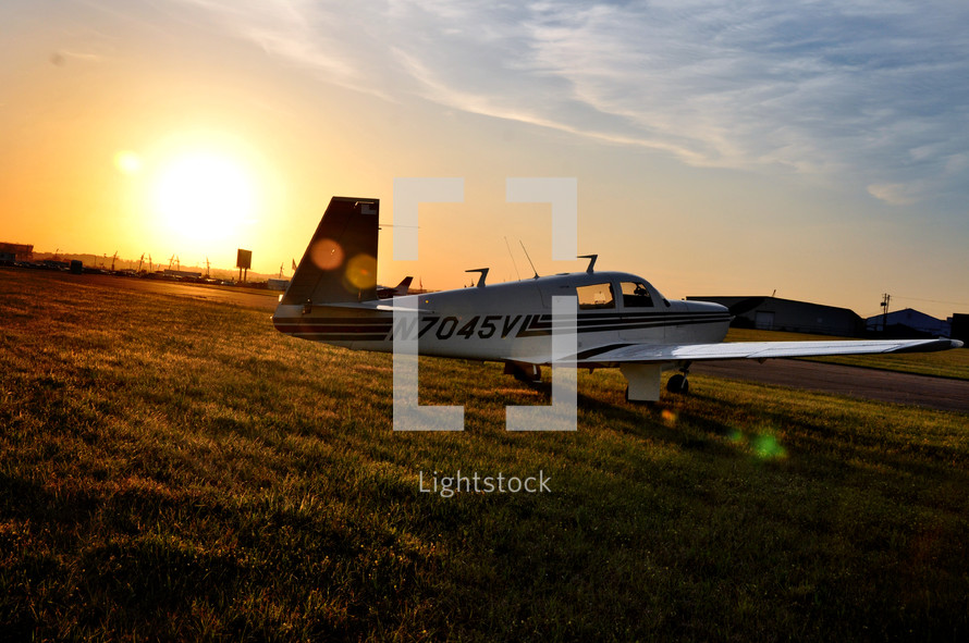 A small plane on a field of grass.