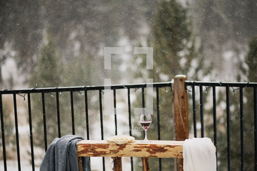 communion wine and bread on outdoor altar under snow fall