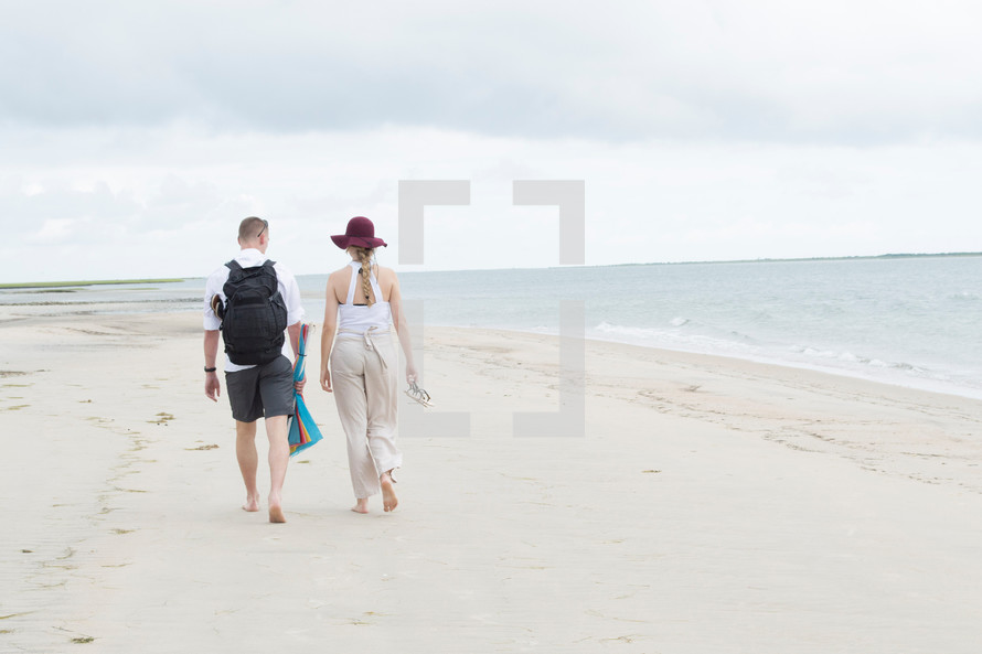 couple walking on a beach 