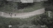 Military surveillance drone view of terrorists walking through a forest